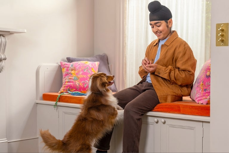 Dog getting treat from boy