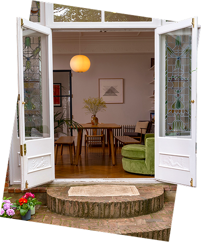 A spacious living and dining room with an open door, connecting indoors with outdoors.