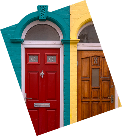 Two house doors displayed side by side, adding charm to the building's exterior.